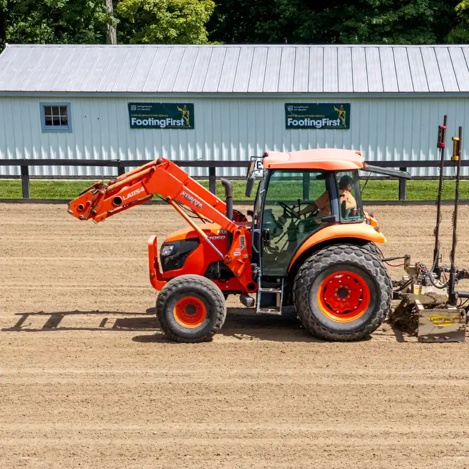 Contractor laser grading horse arena footing.