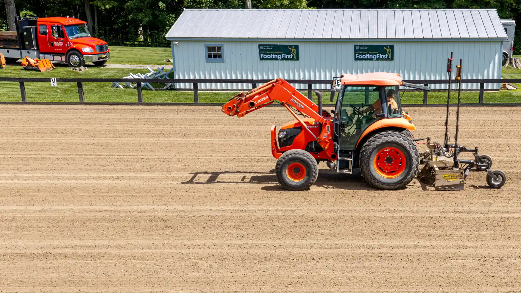 Contractor laser grading horse arena footing.