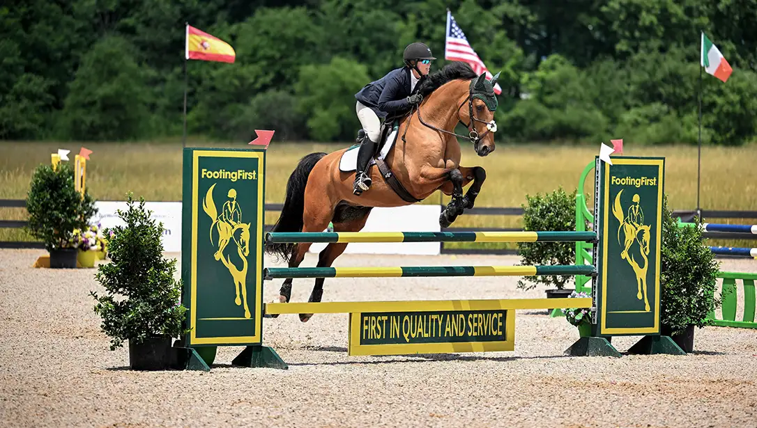 Rider jumping on SRS arena footing